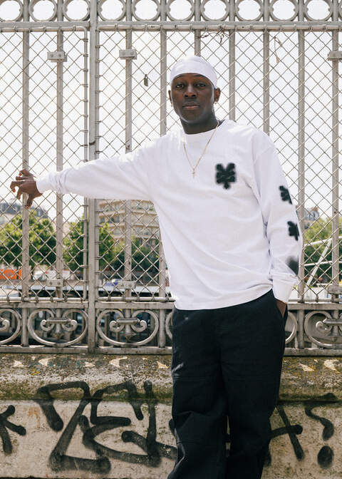 guy wearing a white zoo york longsleeves with black logo