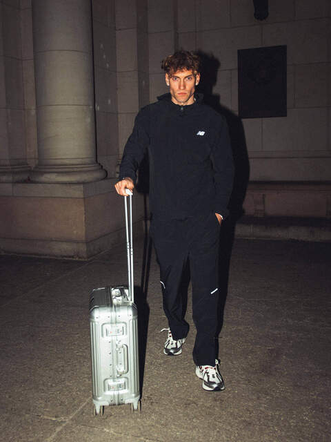 man with suitcase wearing tracksuit